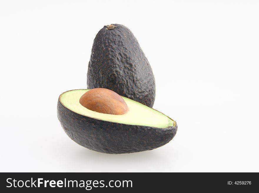 Avocado sliced in half with seed in center. Avocado sliced in half with seed in center