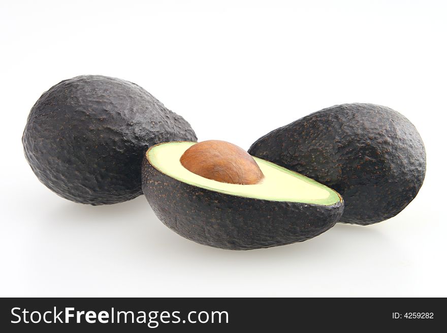 Avocado sliced in half with seed in center. Avocado sliced in half with seed in center