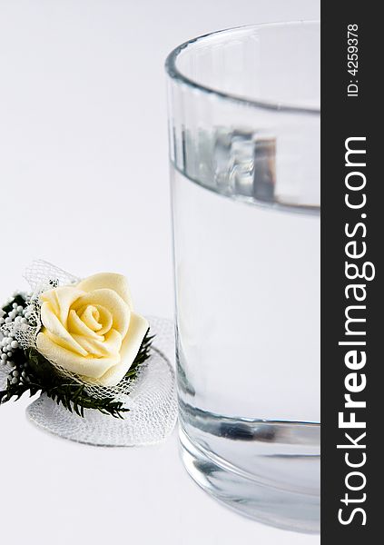 Single rose and glass of water macro close up. Single rose and glass of water macro close up