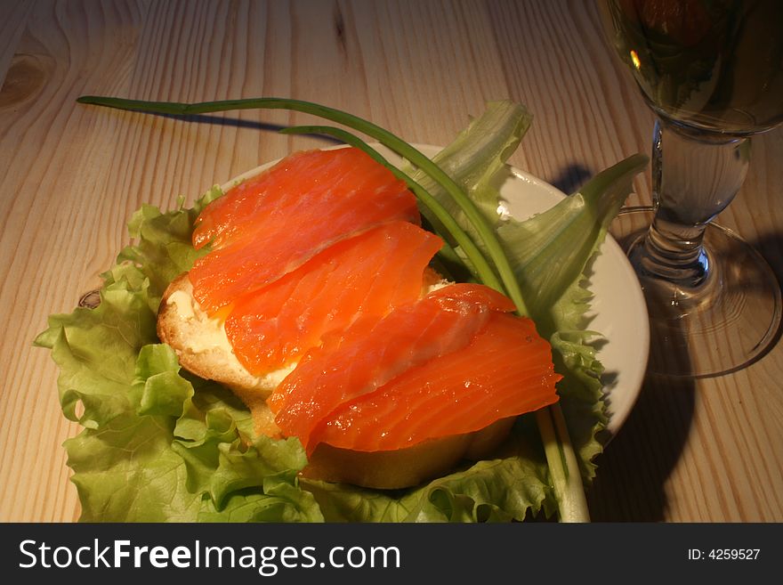 Fish Sandwich With Leaf Lettuce And Bocal On Wooden Table