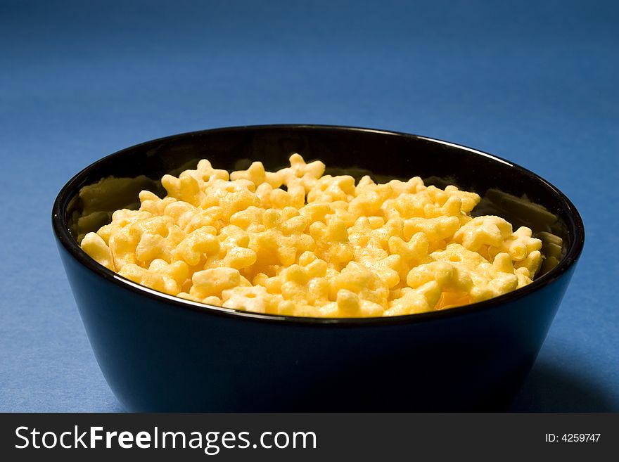 Corn Flakes on blue background. Food and Drink series.