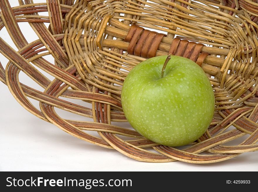 Beautiful green apple on a background of a wum vase. Beautiful green apple on a background of a wum vase.