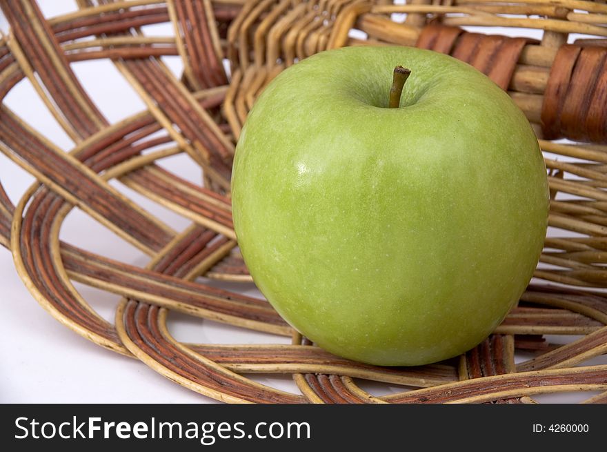 Beautiful green apple on a background of a wum vase. Beautiful green apple on a background of a wum vase.
