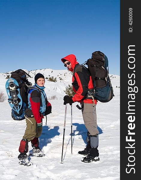 Tourists are in winter in mountains