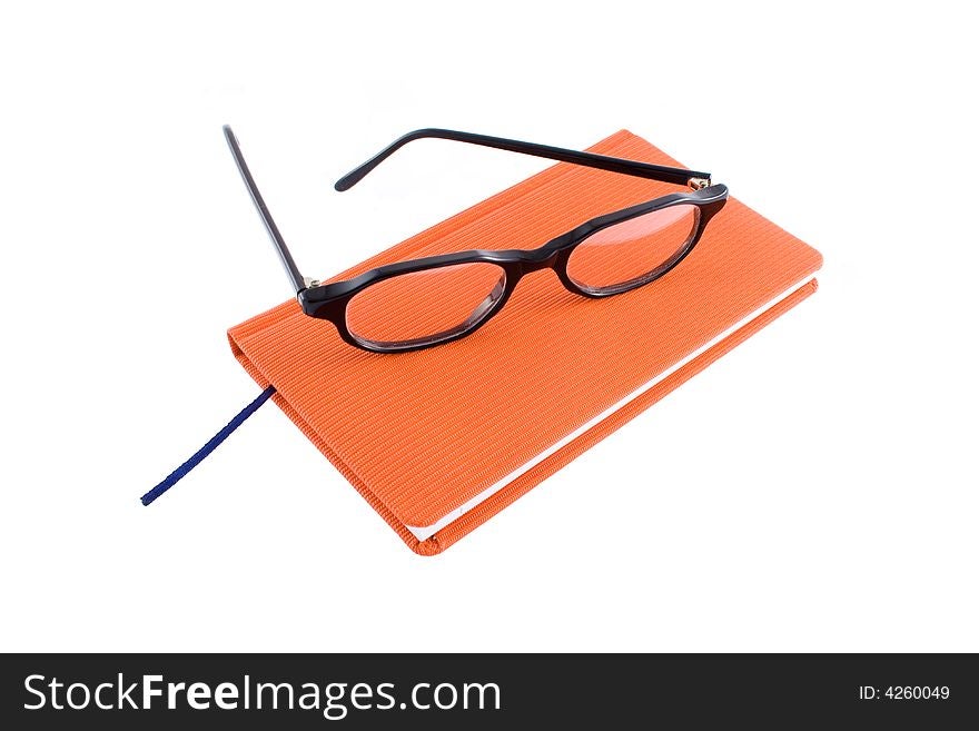 Red calendar and black glasses isolated on  a white background