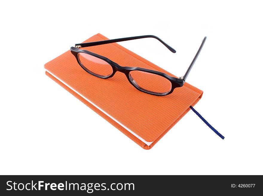 Red calendar and black glasses isolated on  a white background