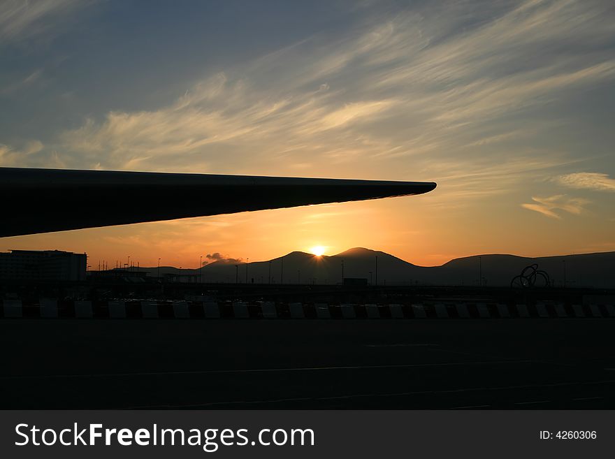 Silhouette of an airplane wing at the airport sunset. Silhouette of an airplane wing at the airport sunset