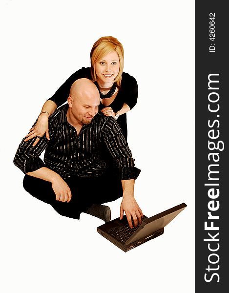 Young lovers sitting on the floor in an studio for white background
and playing on the laptop. Young lovers sitting on the floor in an studio for white background
and playing on the laptop.