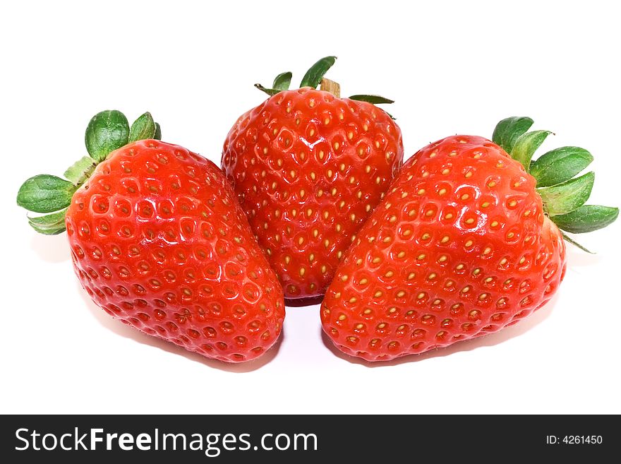Three strawberries closeup isolated on white