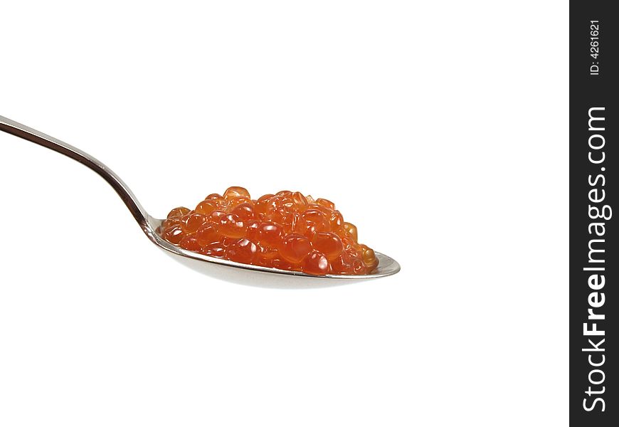The spoon with red caviar isolated on a white background