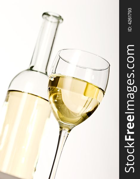 Drink series: white wine glass and bottle over white