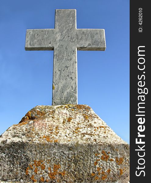 Marble cross against the blue sky