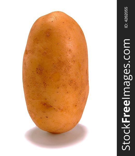 A potato (variety: Agria) standing on end - isolated over pure white. A potato (variety: Agria) standing on end - isolated over pure white