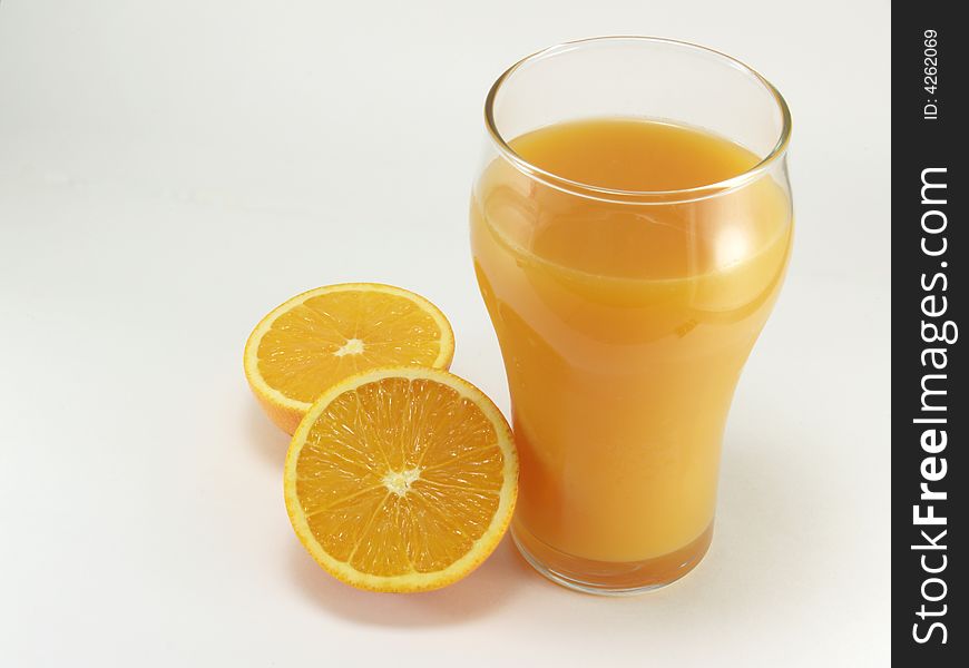 Oranges and glass of orange juice on a white background
