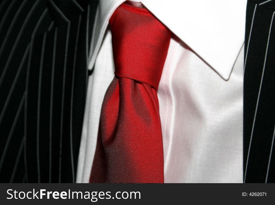 BRIDEGROOM TUX with red tie close up. BRIDEGROOM TUX with red tie close up