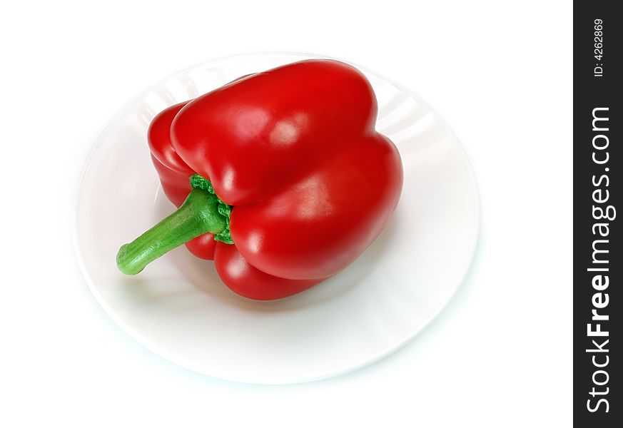 Red pepper on a plate isolated over a white background