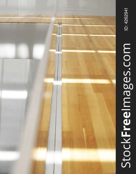 Clean sunlight filters onto blond wood floors. Clean sunlight filters onto blond wood floors