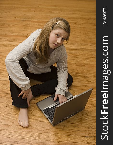 A young girl working on her laptop. A young girl working on her laptop