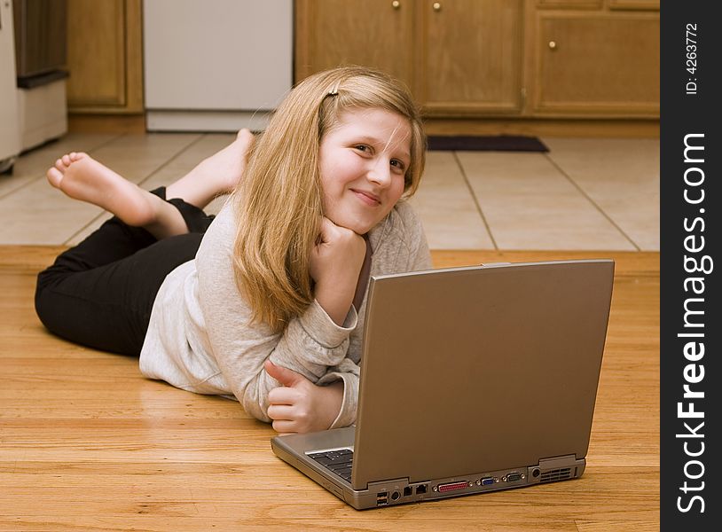 A young girl working on her laptop. A young girl working on her laptop