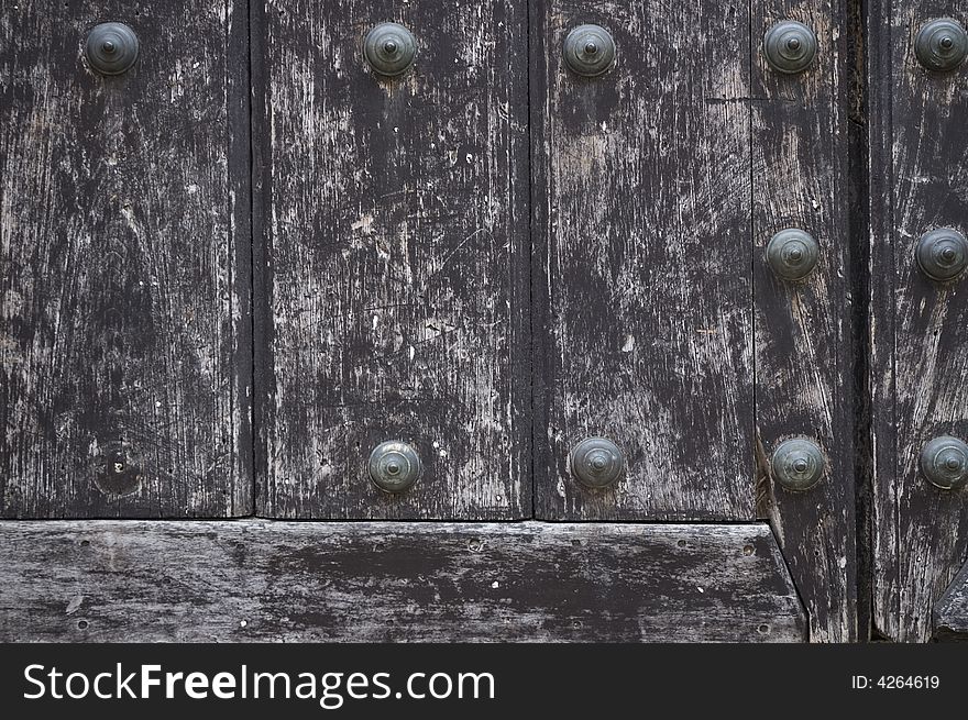 Detail of vintage wooden door with metal bolts. Detail of vintage wooden door with metal bolts