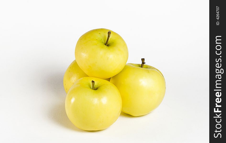 Fresh yellow apples on the white background. Fresh yellow apples on the white background