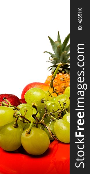 Assortment of fresh fruit arranged on a bright red serving dish. Assortment of fresh fruit arranged on a bright red serving dish.