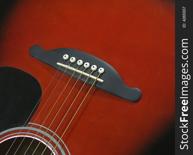 Part of a guitar with the strings. Part of a guitar with the strings