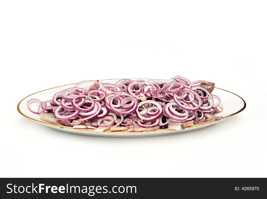 Herring with onion on the plate