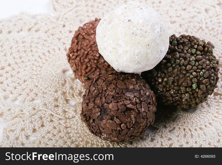 Various types of Chocolate truffles on handmade doily. Various types of Chocolate truffles on handmade doily