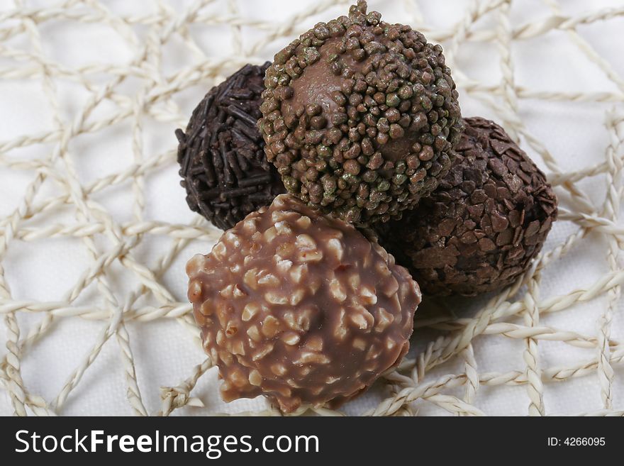 Various types of Chocolate truffles on handmade doily. Various types of Chocolate truffles on handmade doily