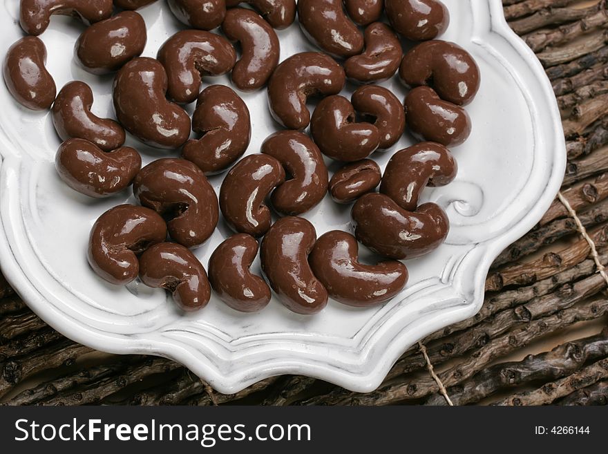 Yummy plate of chocolate covered cashew nuts for sharing or just one. Yummy plate of chocolate covered cashew nuts for sharing or just one.