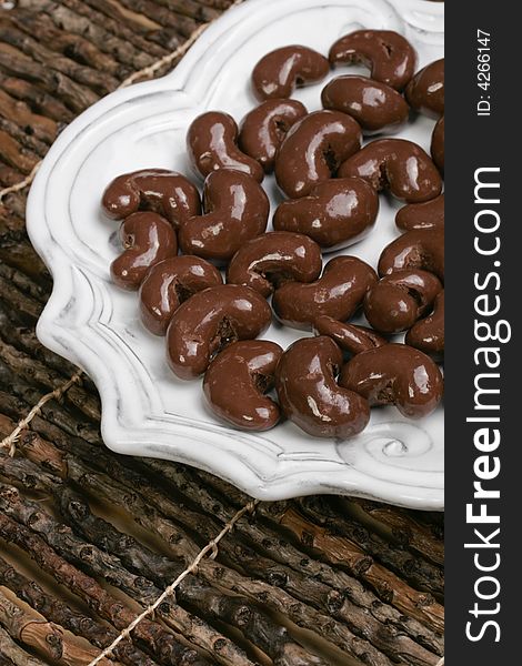 Yummy plate of chocolate covered cashew nuts for sharing or just one. Yummy plate of chocolate covered cashew nuts for sharing or just one.