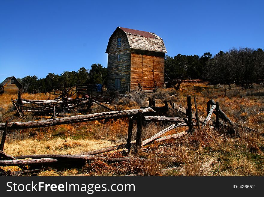 Old Barn with a wood fense in the forground. Old Barn with a wood fense in the forground