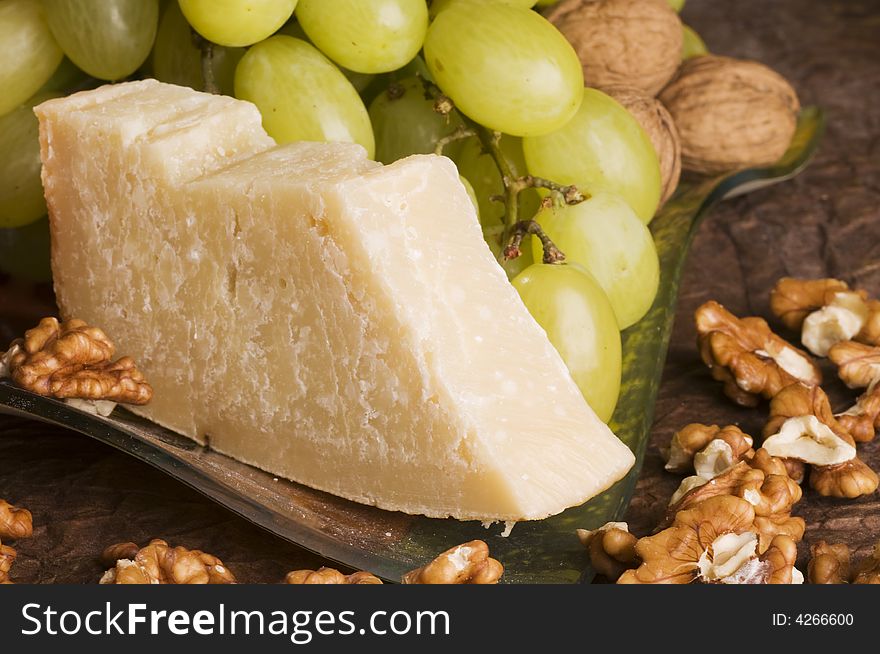 Close-up with cheese, grape, nuts  on a glass plate. Close-up with cheese, grape, nuts  on a glass plate.