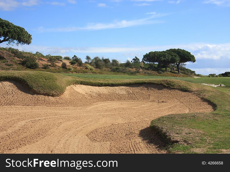 Detail of a sand bunker in a golf field (focus on the bunker)