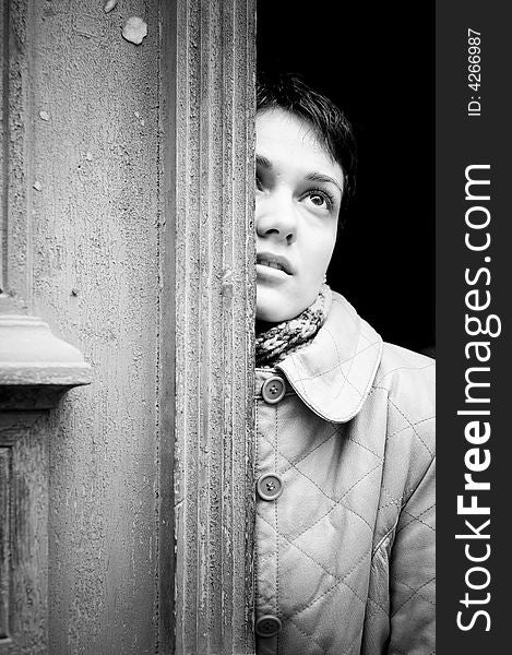 A view with a woman looking up thoughtful in black and white tones.