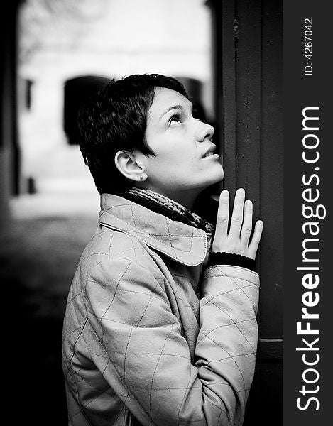 A view with a woman looking up thoughtful in black and white tones.