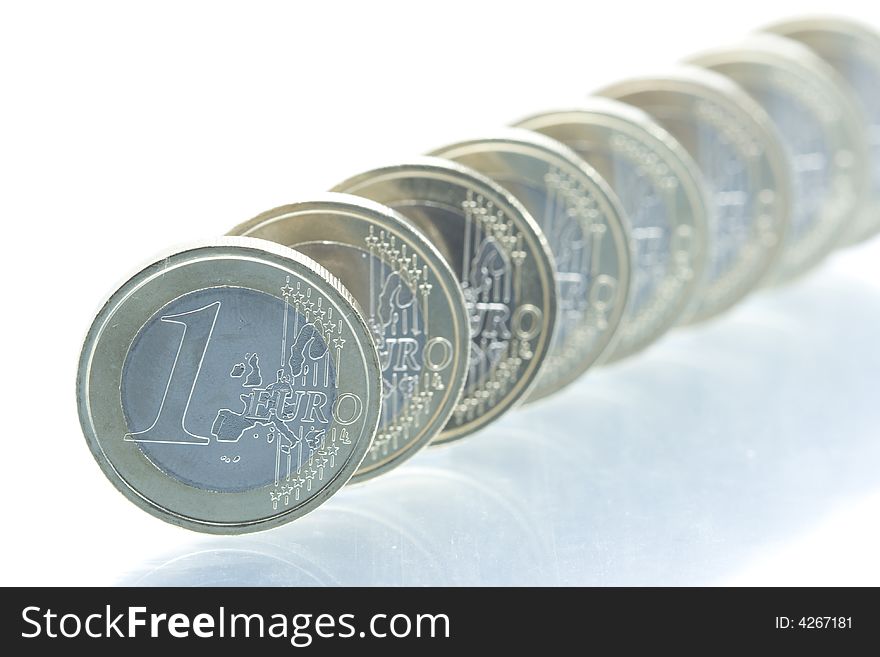 Euro coins line with reflection