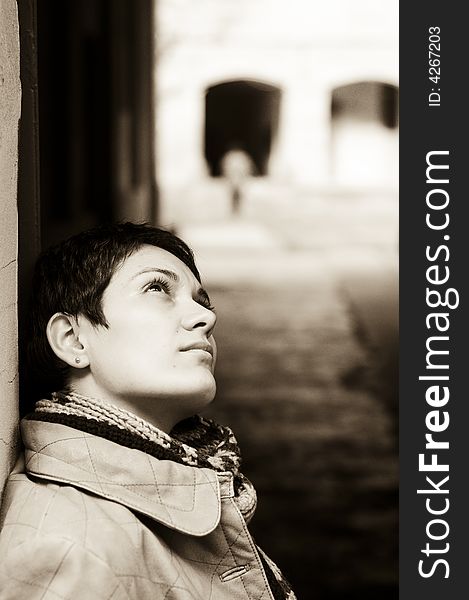 A view with a woman looking up thoughtful in sepia tones.