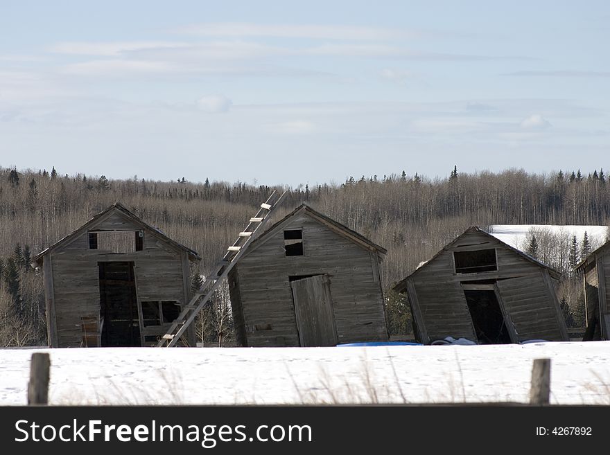 Three leaning outbuidings shoot in the winter. Three leaning outbuidings shoot in the winter.