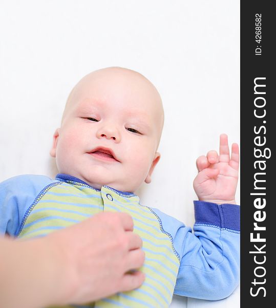 Baby lie on bed and smiling to his mother. Baby lie on bed and smiling to his mother