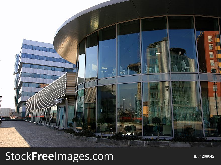 Modern work quarter - Blue buildings offices and round coffe bar structure. Italian architecture. Milan, Italy. Modern work quarter - Blue buildings offices and round coffe bar structure. Italian architecture. Milan, Italy