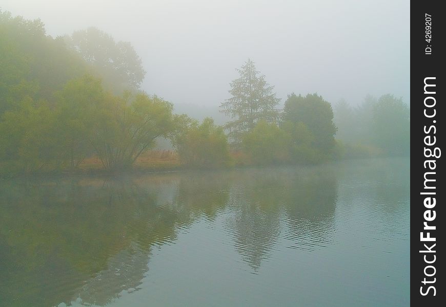 A heavy fog covers this lake in Freehold New Jersey in early Fall. A heavy fog covers this lake in Freehold New Jersey in early Fall.