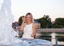 Young Beautiful Woman In A White Dress Near The Fountain Royalty Free Stock Photography Young Beautiful Woman In A White Dress Near The Fountain Royalty Free Stock Photography