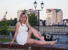 Young Beautiful Woman In White Dress Sitting On A Park Bench Stock Photo Young Beautiful Woman In White Dress Sitting On A Park Bench Stock Photo