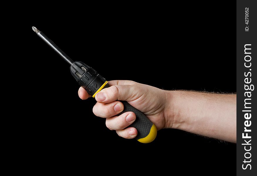 Screwdriver in hand. Isolated on a black background.