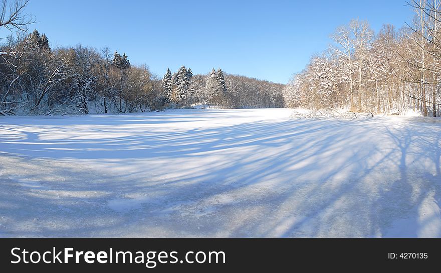 Panoramic view of lake in silence winter forest. Panoramic view of lake in silence winter forest