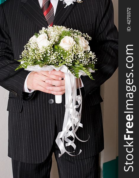 A beautiful rose bouquet in the hands of a man