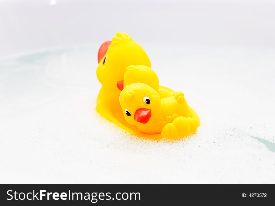 Three Rubber Ducks In Foam Water