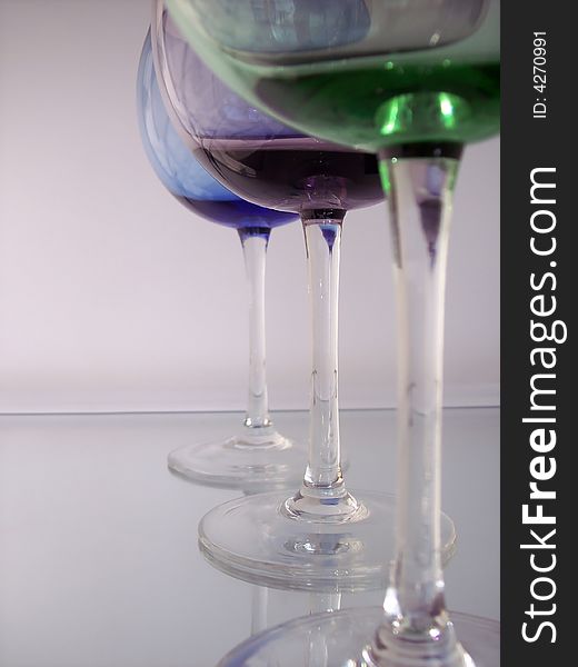 Different colored wine glasses arranged in different formations